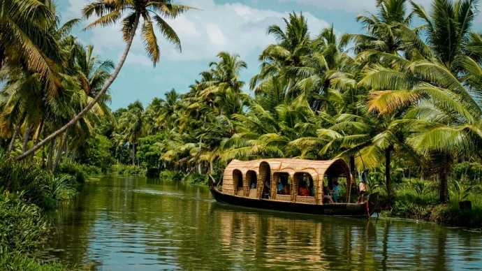 brown boat on body of water near green trees during daytime