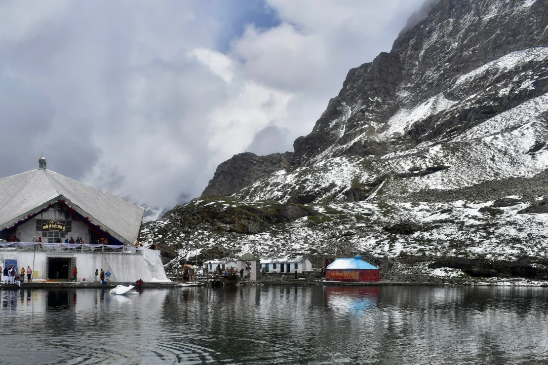 a boat in a body of water with a mountain in the background